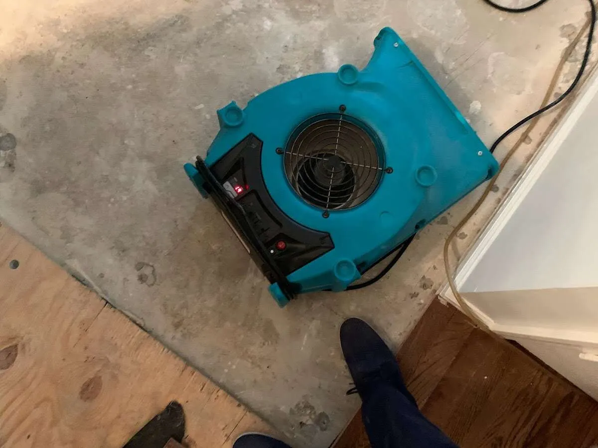 Air mover drying subfloor during Leak Detection & Repair in Superior